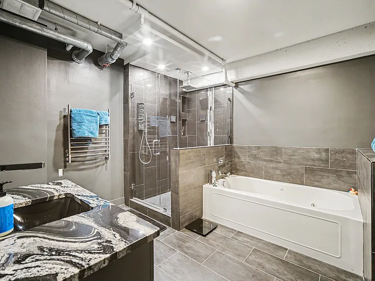 Master bathrooms features soak in bathtub with jets, massive shower with rain head and 2 additional wall shower heads and handheld shower head, backlit mirror, towel warmer, and bidet