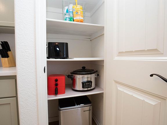 A welcome basket of cleaning supplies (including laundry and dishwasher pods), toaster, air fryer, crock pot)