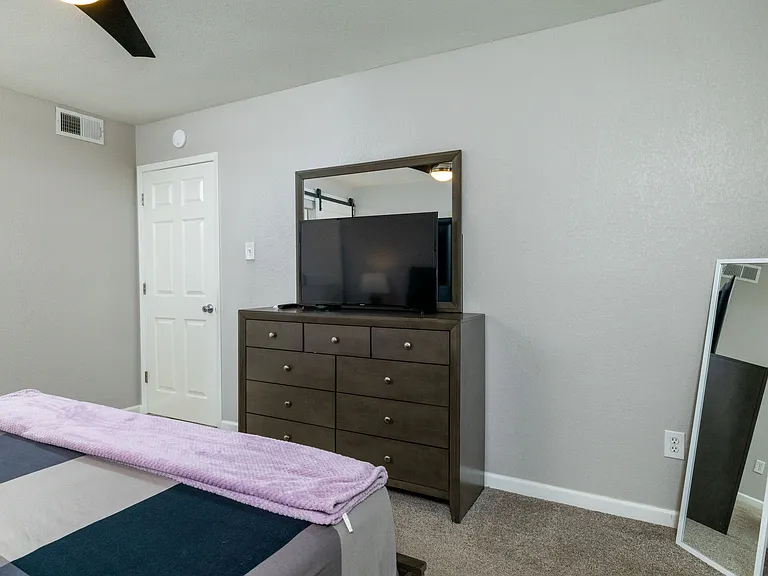 Bedroom 2 with king bed and door to patio with attached bathroom.
