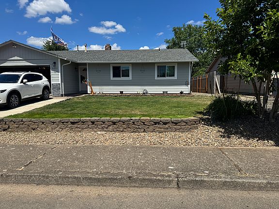 Front of house. Before 8/1, front door will be painted black and have a new garage door.