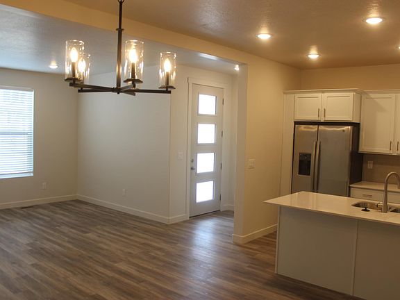 Entry with open plan kitchen, living, and dining.