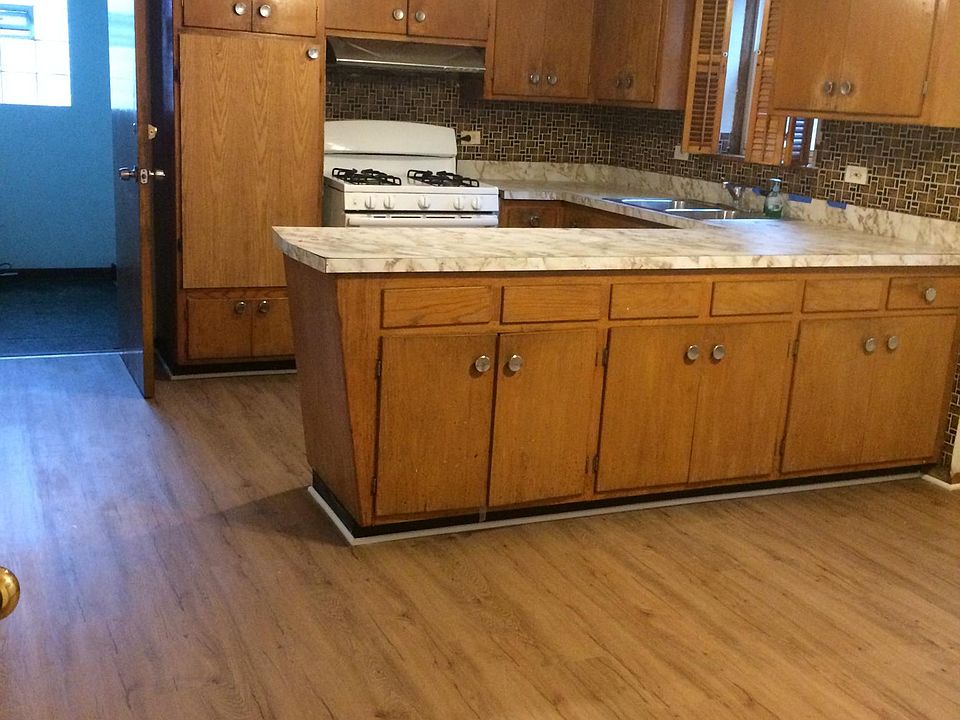 Large kitchen with new floors. Lots of cabinet space.