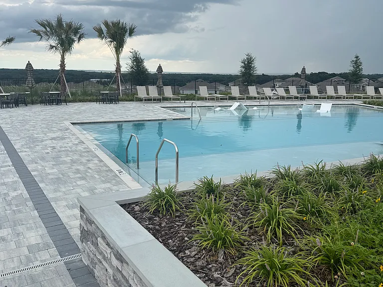 Pool area - Right Pool w/ deck & umbrellas