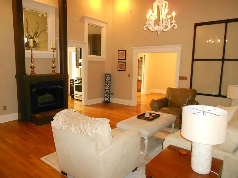 Another view of living room which shows fireplace.