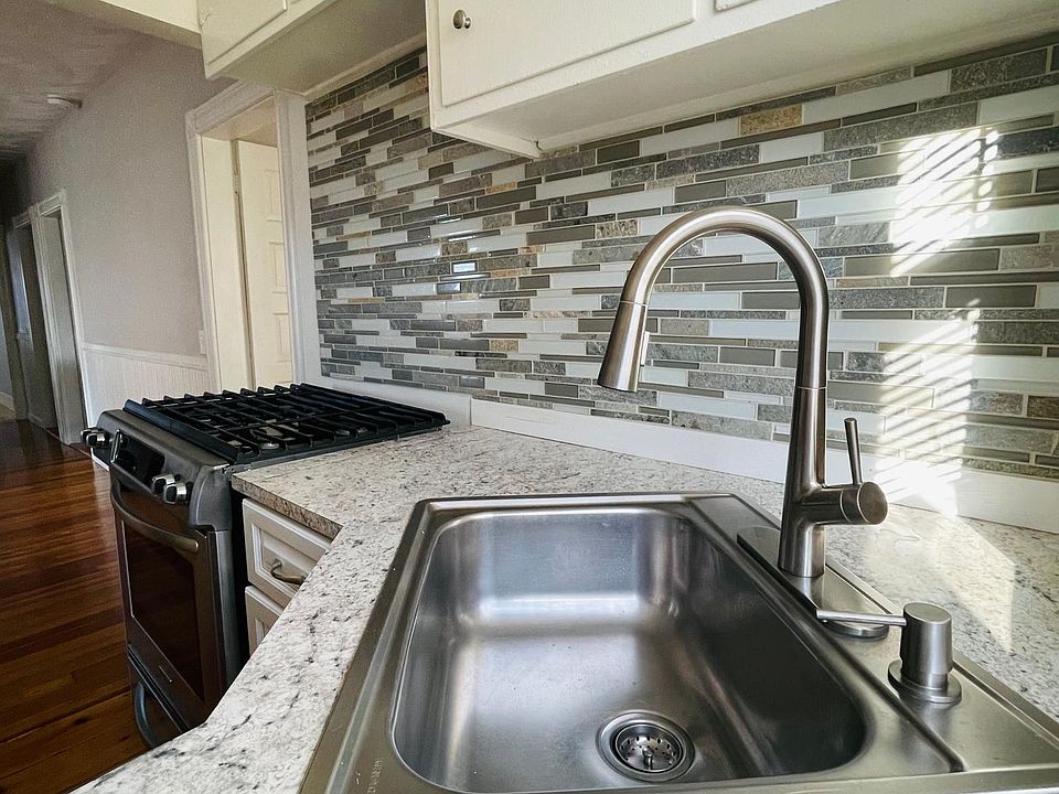 Newly installed backsplash, faucet, oven and fridge