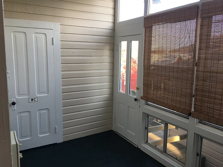 Rear sunroom with door to new half bath
