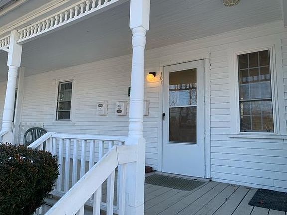 Front porch and exterior door to the apartment.