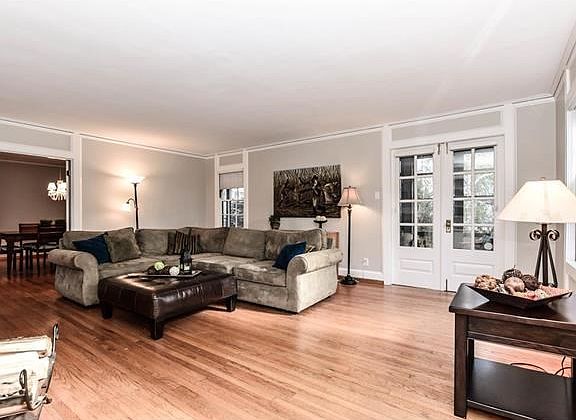 Great room on front of home. Screened in porch thru french doors to right.  Dining room straight back thru second set of french doors. All new paint throughout the home.