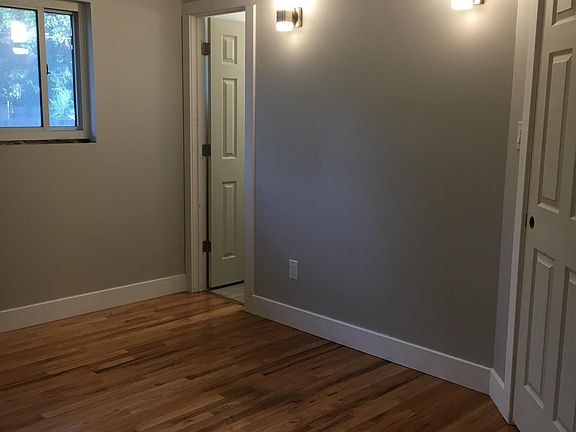 Master bedroom. Door on the right side of the photo leads to hallway, door in left corner of the bedroom leads to master bathroom. Ceiling fan/light and wall sconces are controlled by independent wall switches.