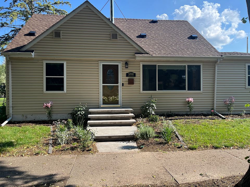 Front yard with fresh landscaping and new, modern concrete steps installed last year.
