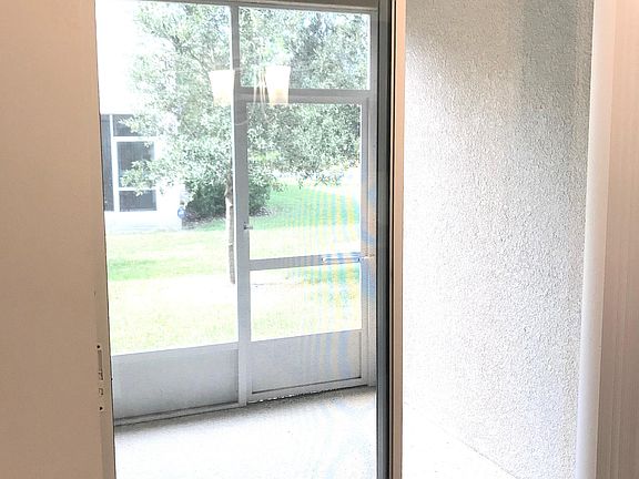 New screened-in patio perfect for lounging and grilling