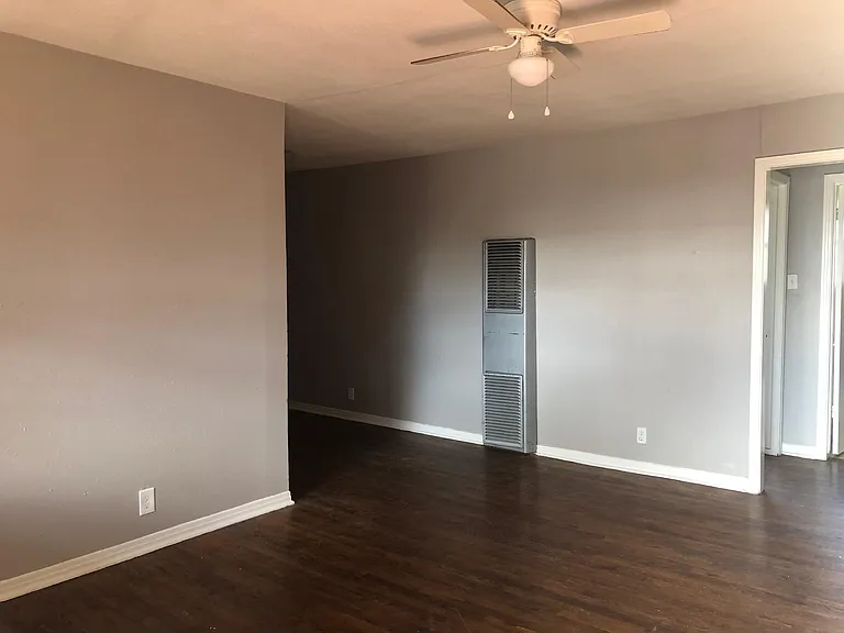 living room view to dining nook and hall