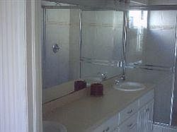 Two sinks with walk in closet.
