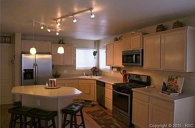 Cooks kitchen with brand new stainless steel appliances and hard
