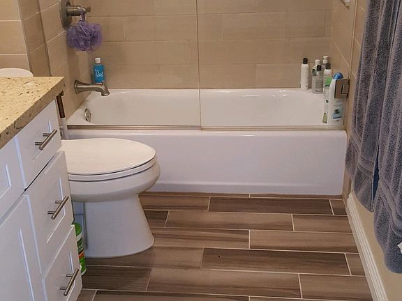 Remodeled Bathroom with Wall to Ceiling Shower Glass, Designer Tile and Fixtures