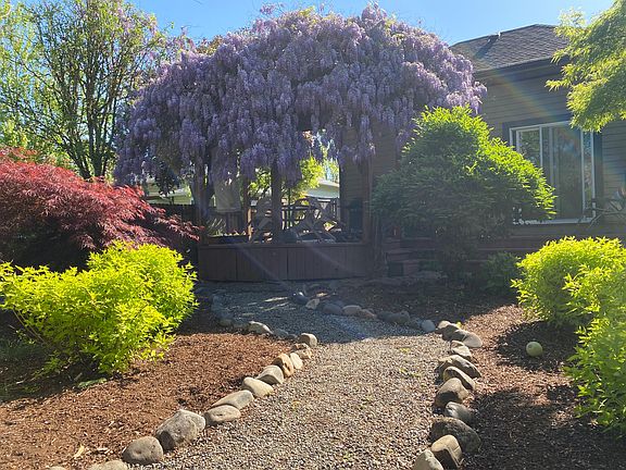 Large yard with mature trees, two gazebos/pergolas