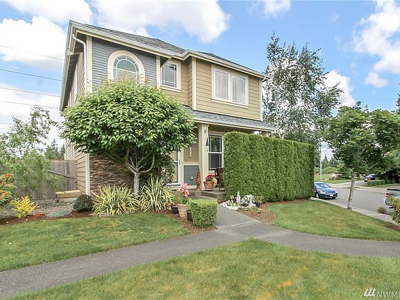 All of your landscaping is maintained by the HOA, even the side yard with beautiful corkscrew willow. They even trim the gorgeous green arborvitaes that provide privacy for the extra large covered front porch!