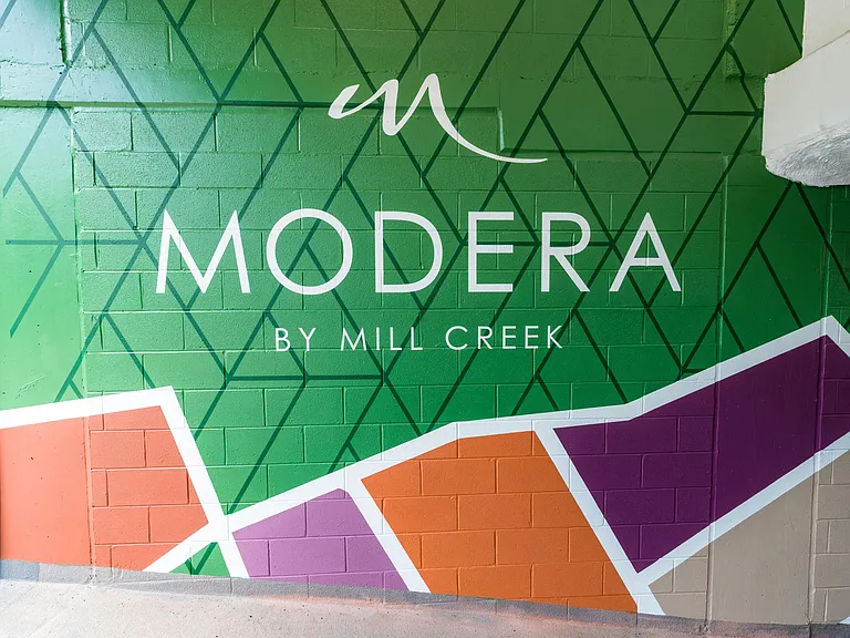 Vibrant, modern, and unmistakably Modera_our branded garage mural sets the tone the moment you arrive.