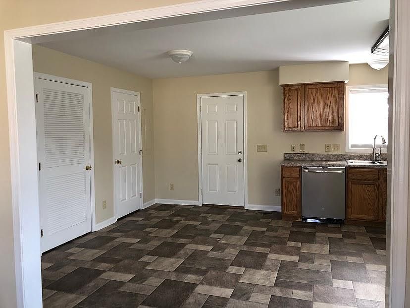 Living room view of kitchen, back door and pantry door