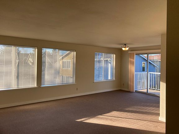 Large, sunny living room with deck