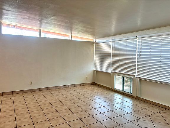 Living area with ceramic tile and large windows