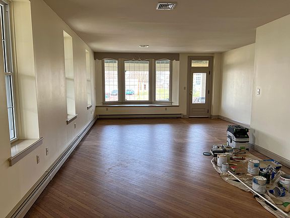 Enormous living room with so much natural light. The original hardwood white oak floors have been fully refinished (they are dusty in the pictures from renovation work)