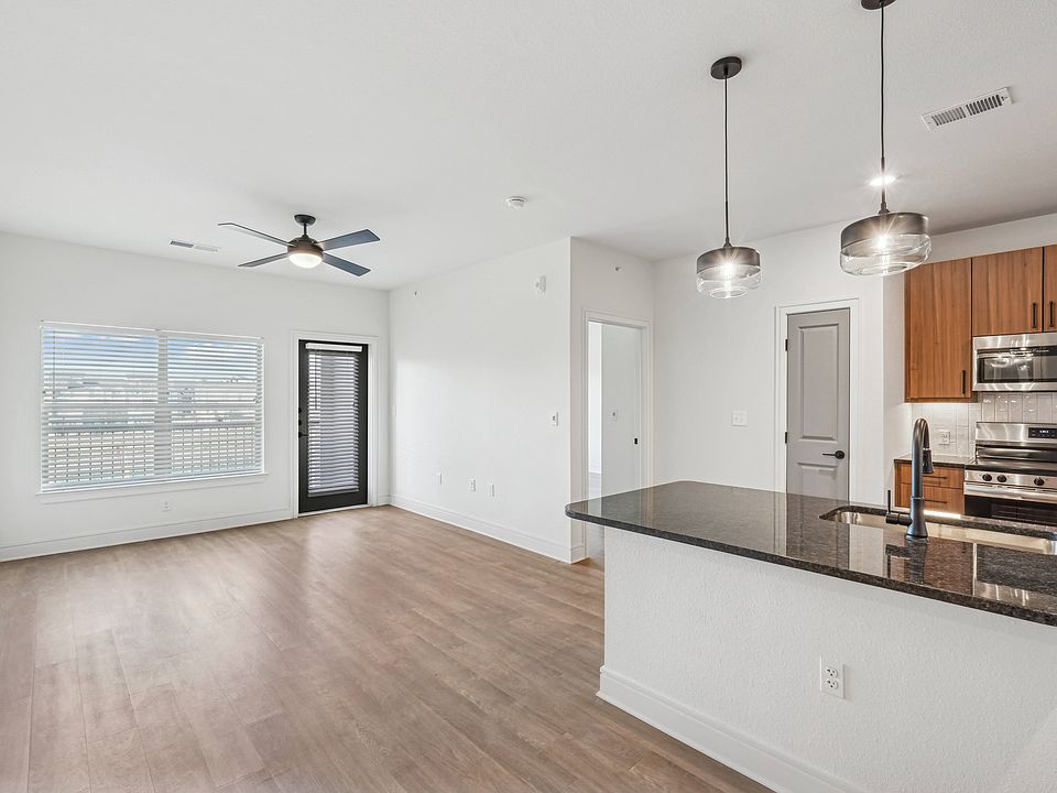 Kitchen Peninsula with Seating Space and View into Living Room