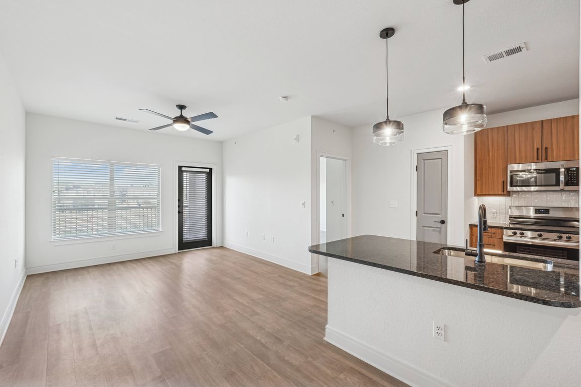 Kitchen Peninsula with Seating Space and View into Living Room