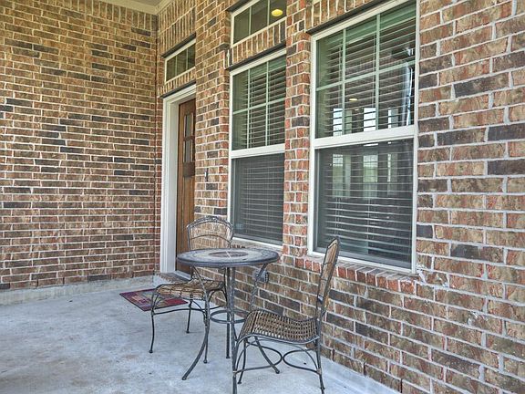 Spacious covered front porch is the perfect place to unwind after a long day at work.