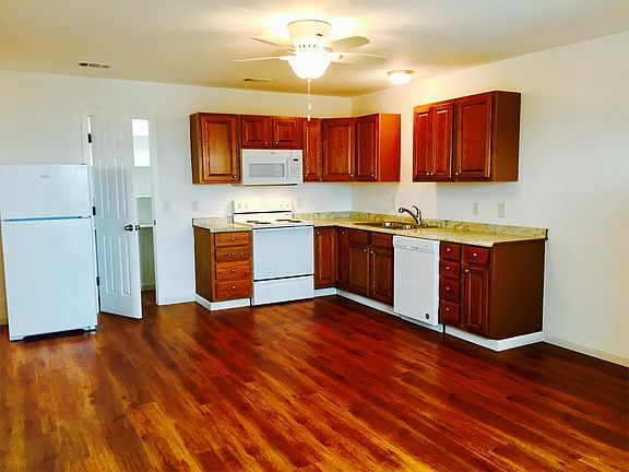 Duplex distance view of kitchen and pantry from living area