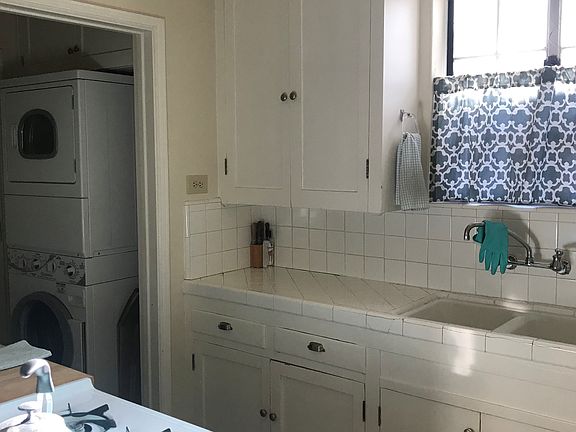 Note stackable w/d off kitch