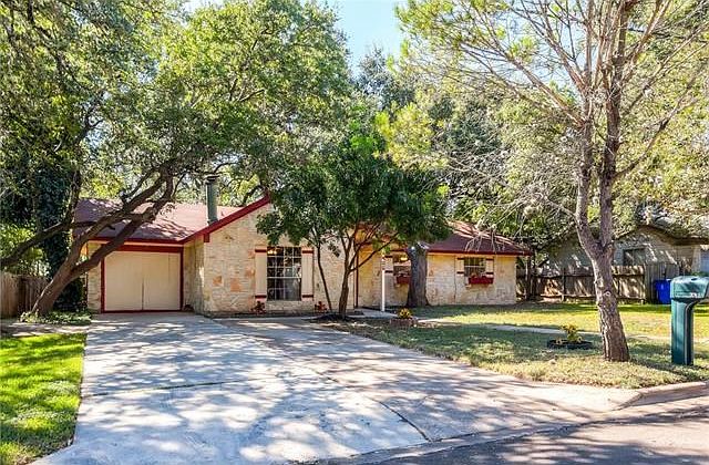 Front of the house filled with plenty of oak trees.
