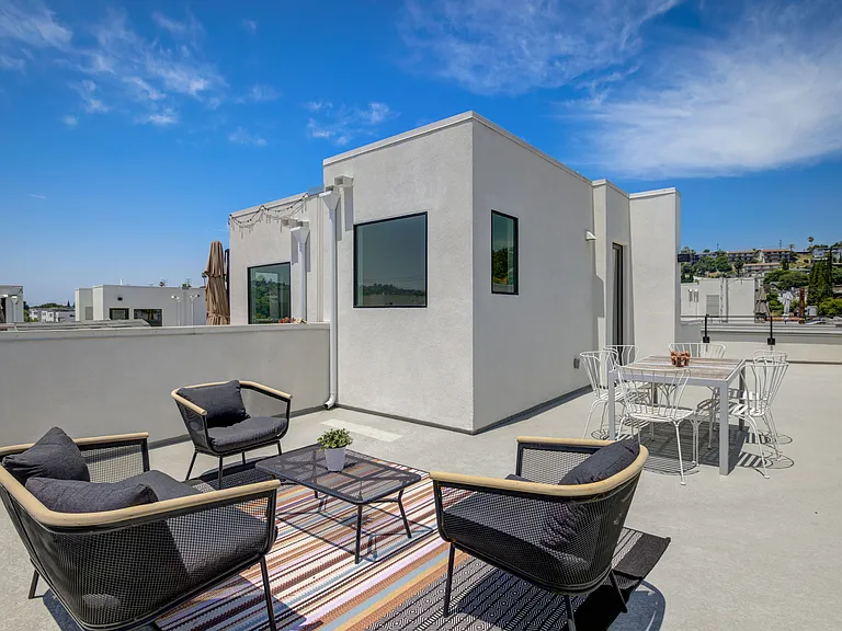 Expansive rooftop deck with mountain views, perfect for entertaining, outdoor dining, and relaxing.