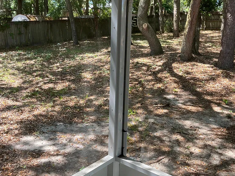 Back patio and large fenced-in, natural backyard