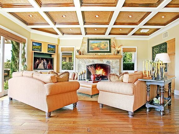 This Comfortable Family Room Offers Rich Colors And A Large Stone Fireplace