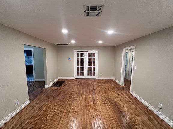 Living room. Taken standing in front of the fireplace. Dining room to the left. Bedrooms to the right.