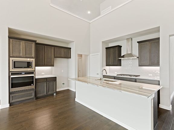 Kitchen in the McCartney home plan by Trophy Signature Homes - REPRESENTATIVE PHOTO