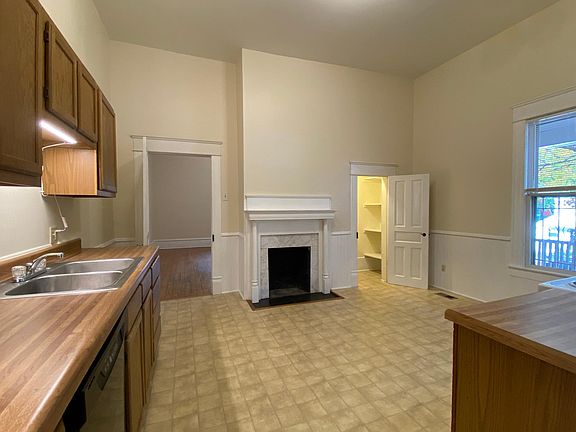 The eat-in kitchen includes a pantry and decorative fireplace.
