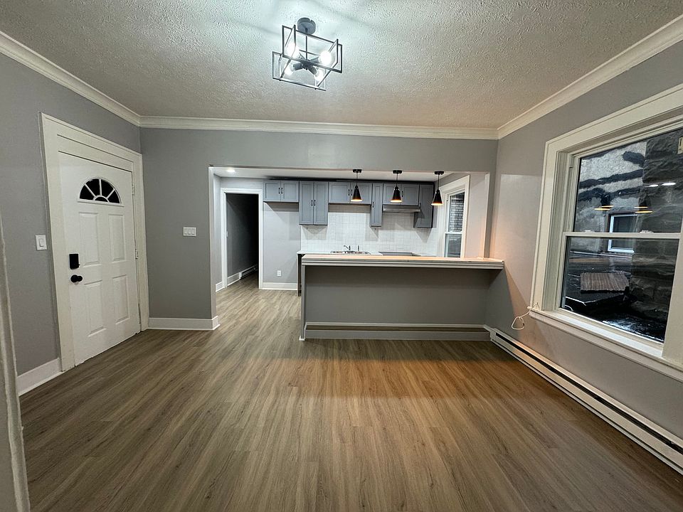Spacious living room with beautiful natural light and updated flooring.