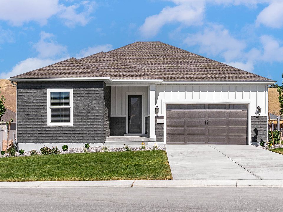 The Crawford is a beautiful single-story home with siding and brick.