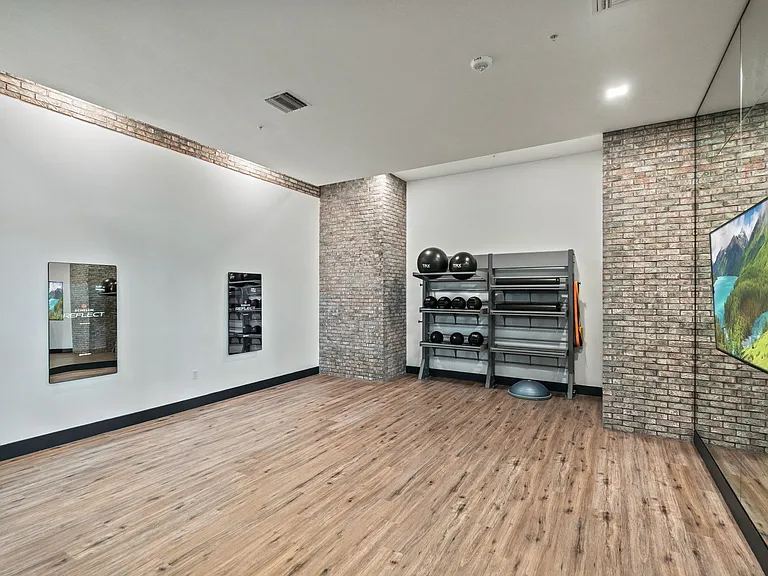 Yoga studio with customized workouts from a personalized mirror trainer.