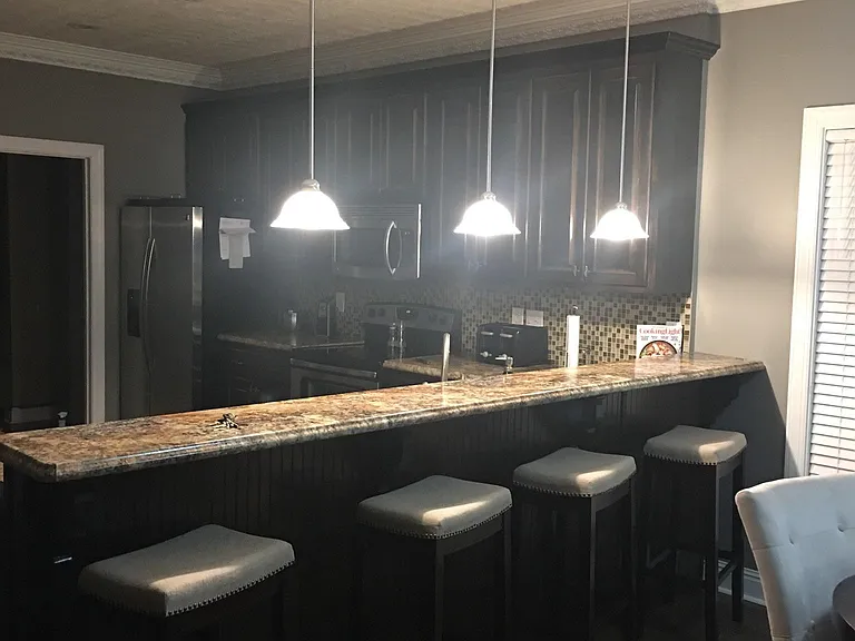 Kitchen with oversized bar and stainless steel appliances