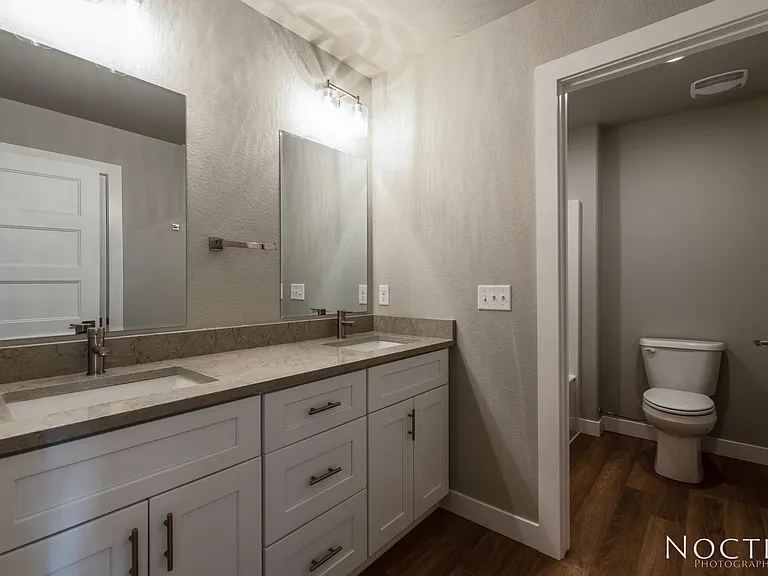 Guest bath off upstairs next to the two large bedrooms. (Photo of another unit with similar finishes and quality.)