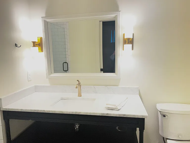 Primary Bath with marble and brass and shower