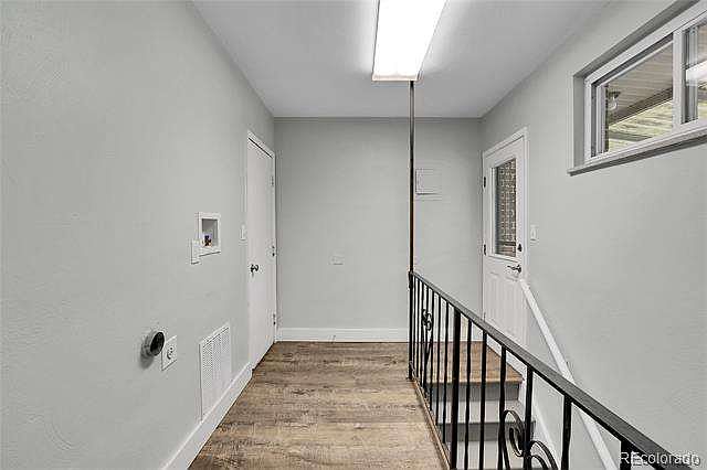 Hallway to garage, patio and to lower level