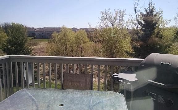 View from deck to a wooded private back yard.