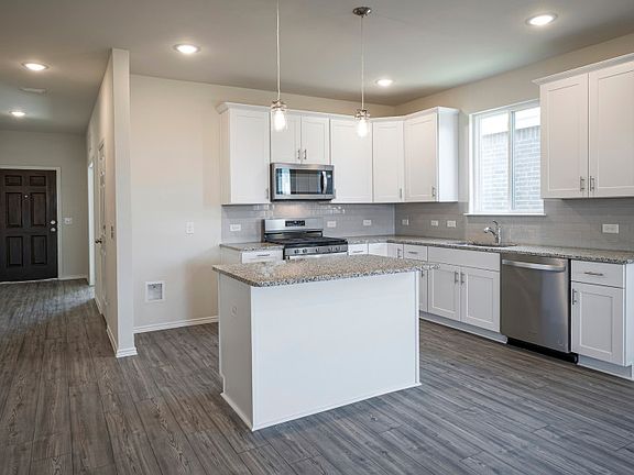 Island kitchen with recessed lighting.