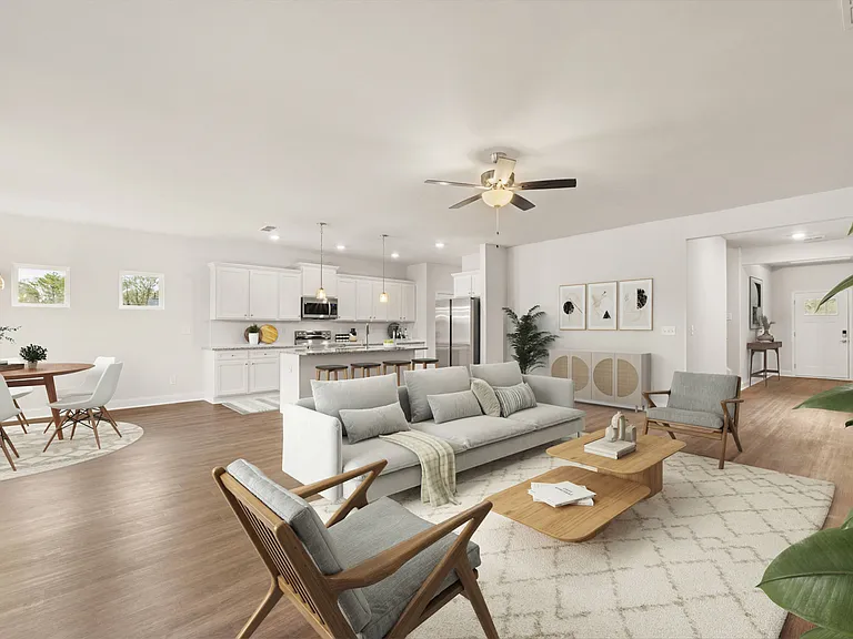 View of the kitchen and entry hallway. Offering bar seating, plenty of cabinet space and granite countertops.