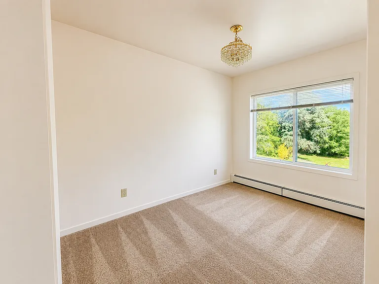 The dining room is spacious and bright, and also overlooks the grounds. This could also be a nice home office area.