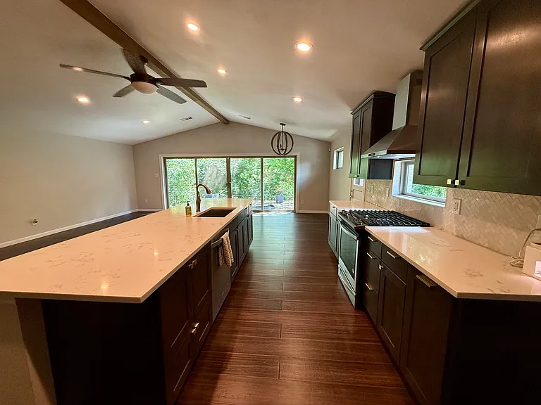 Kitchen and dining. Gas stove top. Microwave in the lower cupboard. Large island with plenty of counter space.